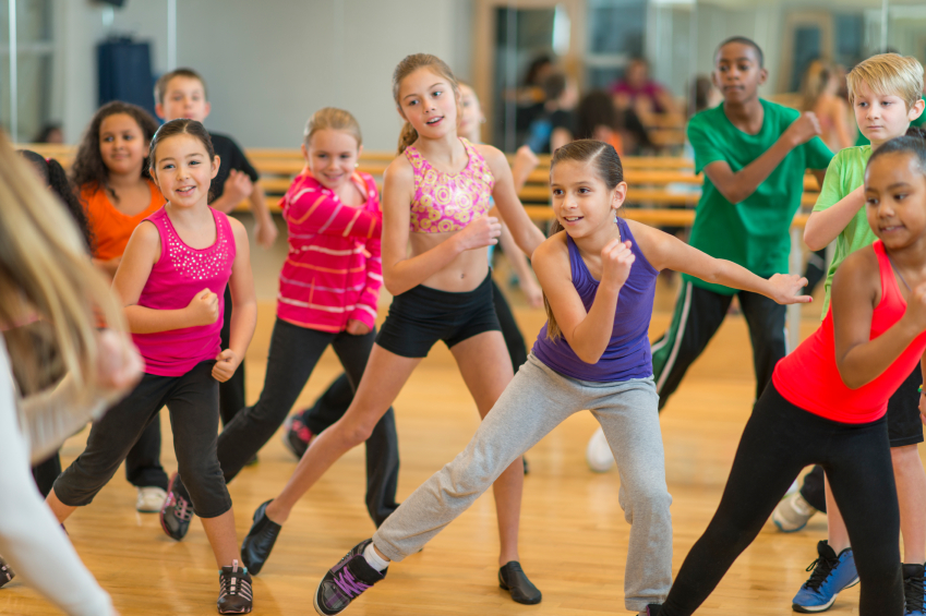 Diverse group of children taking a zumba dance fitness class